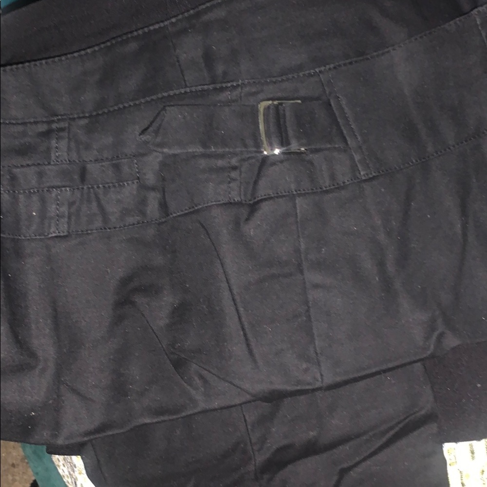 Black jeans both sides have little belt type design  and bottom has buttons